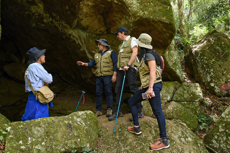 Representantes da UNESCO com o coordenador cientfico do geoparque, gelogo Andr Borba, na Caverna da Escurido, durante o trajeto da trilha na Pedra do Segredo. Estas grutas so comuns na regio, esculpidas pela passagem das guas subterrneas